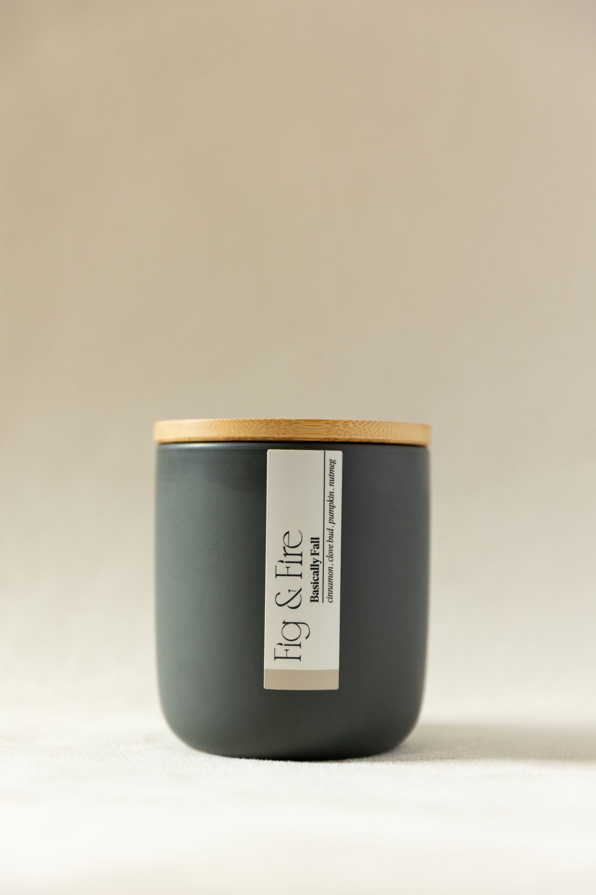 Handcrafted fall candle - scent is Basically Fall - smells of pumpkin, cinnamon, nutmeg, clove - all natural soy candle - vegan, non-toxic, made with essential oils - container is a charcoal ceramic tumbler with light brown wooden lid from bamboo