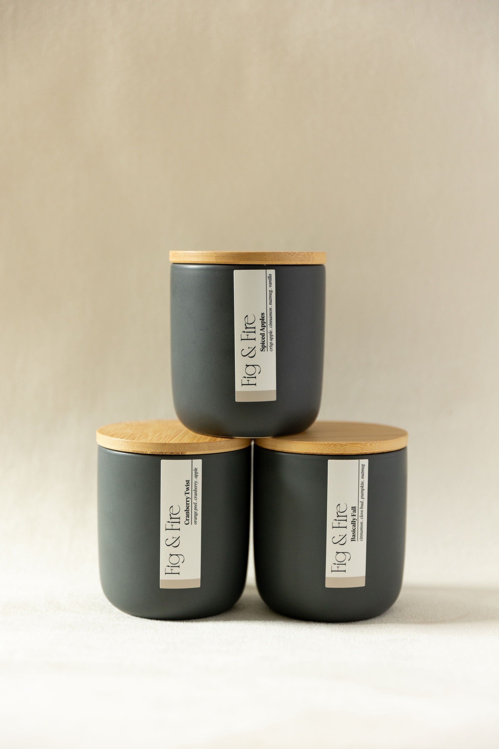 The entire fall collection is featured - Basically Fall, Cranberry Twist, and Spiced Apples - the vessels are charcoal ceramic tumblers with bamboo wooden lids - all-natural, vegan, soy candles made with essential oils