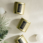 3 gold tin candles - The entire winter collection is featured, with a burn time of 24+ hours each: Cranberry Twist, Snowy Evening, and Winter Woods - non-toxic, all-natural, cruelty-free, vegan, soy candles made with essential oils