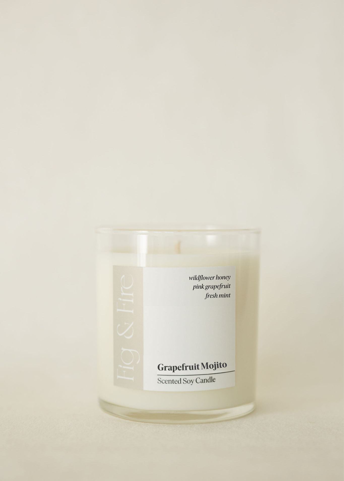 Handcrafted candle - scent is Grapefruit Mojito - scent notes are wildflower honey, pink grapefruit, and fresh mint - all natural soy candle - vegan, non-toxic, made with essential oils - container is a clear glass tumbler