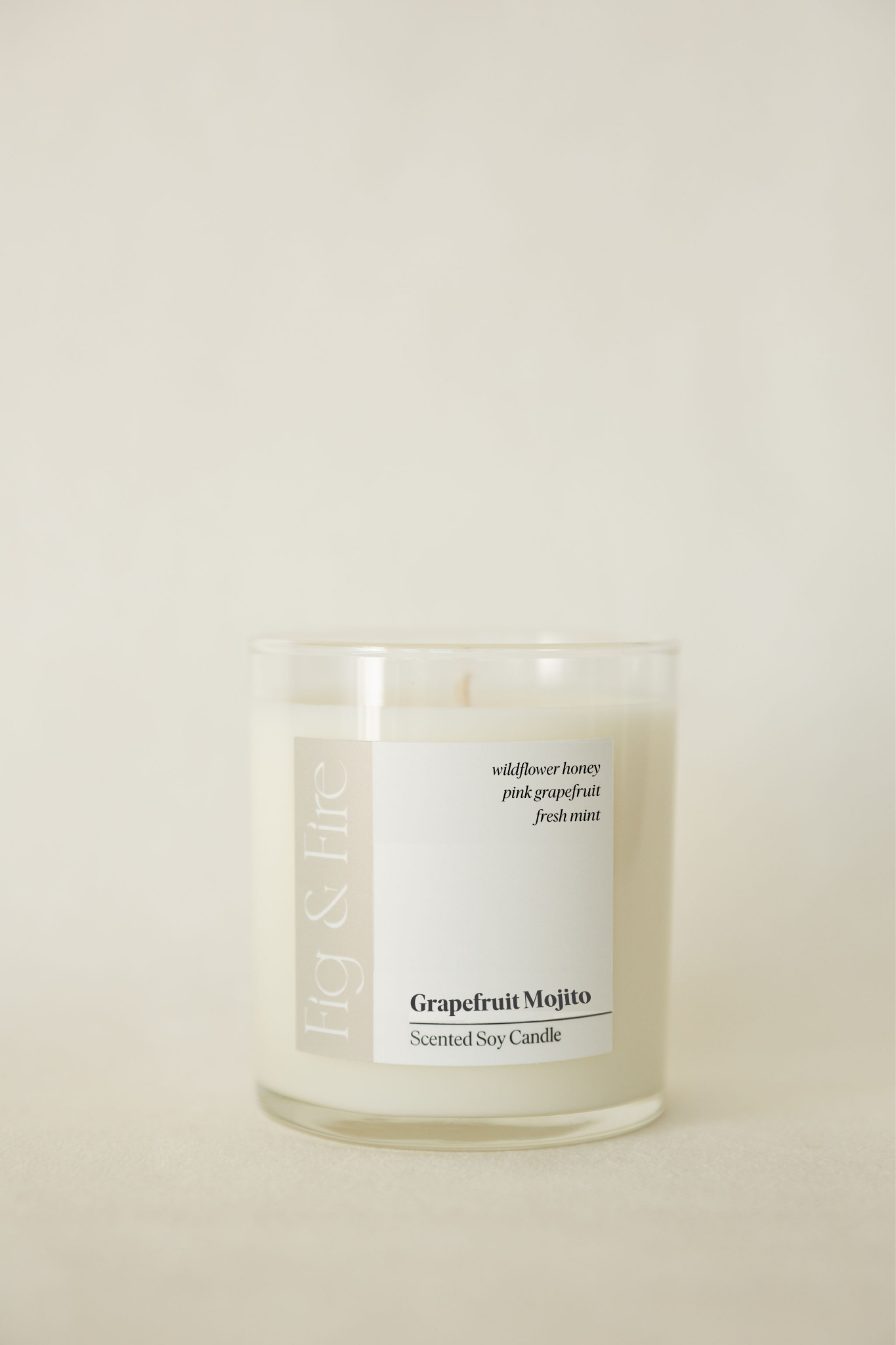 Handcrafted candle - scent is Grapefruit Mojito - scent notes are wildflower honey, pink grapefruit, and fresh mint - all natural soy candle - vegan, non-toxic, made with essential oils - container is a clear glass tumbler