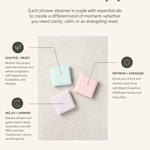 Three shower steamers made with essential oils on a neutral background, featuring text about their uses and ingredients. Breathe Deeply. Each shower steamer is made with essential oils to create a different kind of moment—whether you need clarity, calm, or an energizing reset.