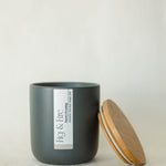 Handcrafted winter candle - scent is snowy evening - smells of clove, pine, orange, and cinnamon - all natural soy candle - vegan, non-toxic, made with essential oils - seasonal collection - container is a charcoal ceramic tumbler