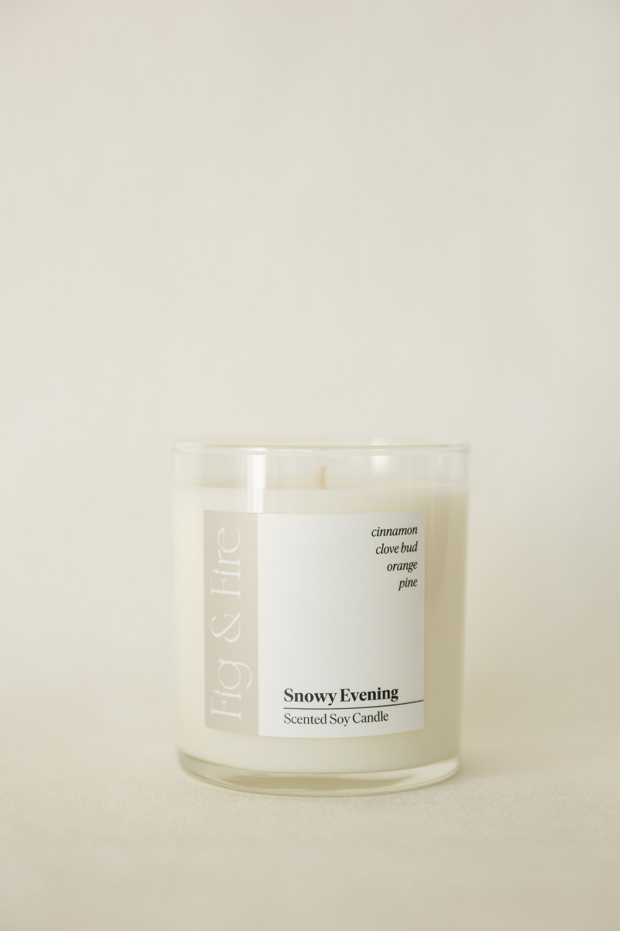 Handcrafted winter candle - scent is snowy evening - smells of clove, pine, orange, and cinnamon - all natural soy candle - vegan, non-toxic, made with essential oils - seasonal collection - container is a clear glass tumbler