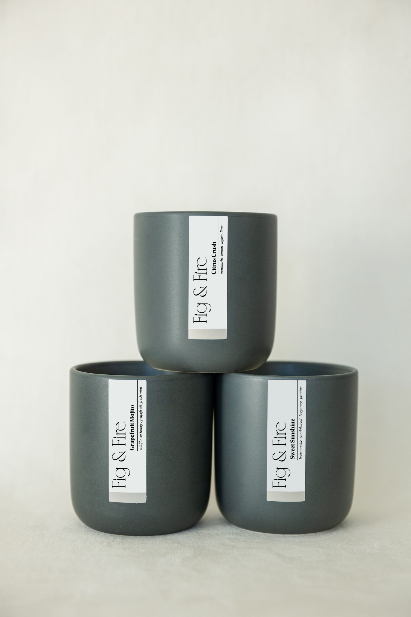The entire spring collection is featured - Citrus Crush, Grapefruit Mojito, Sweet Sunshine - the vessels are charcoal ceramic tumblers - all-natural, vegan, non-toxic soy candles made with essential oils