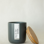 Handcrafted candle - scent is Sweet Sunshine - scent notes are honeysuckle, sandalwood, bergamot, jasmine - all natural soy candle - vegan, non-toxic, made with essential oils - container is a charcoal ceramic tumbler