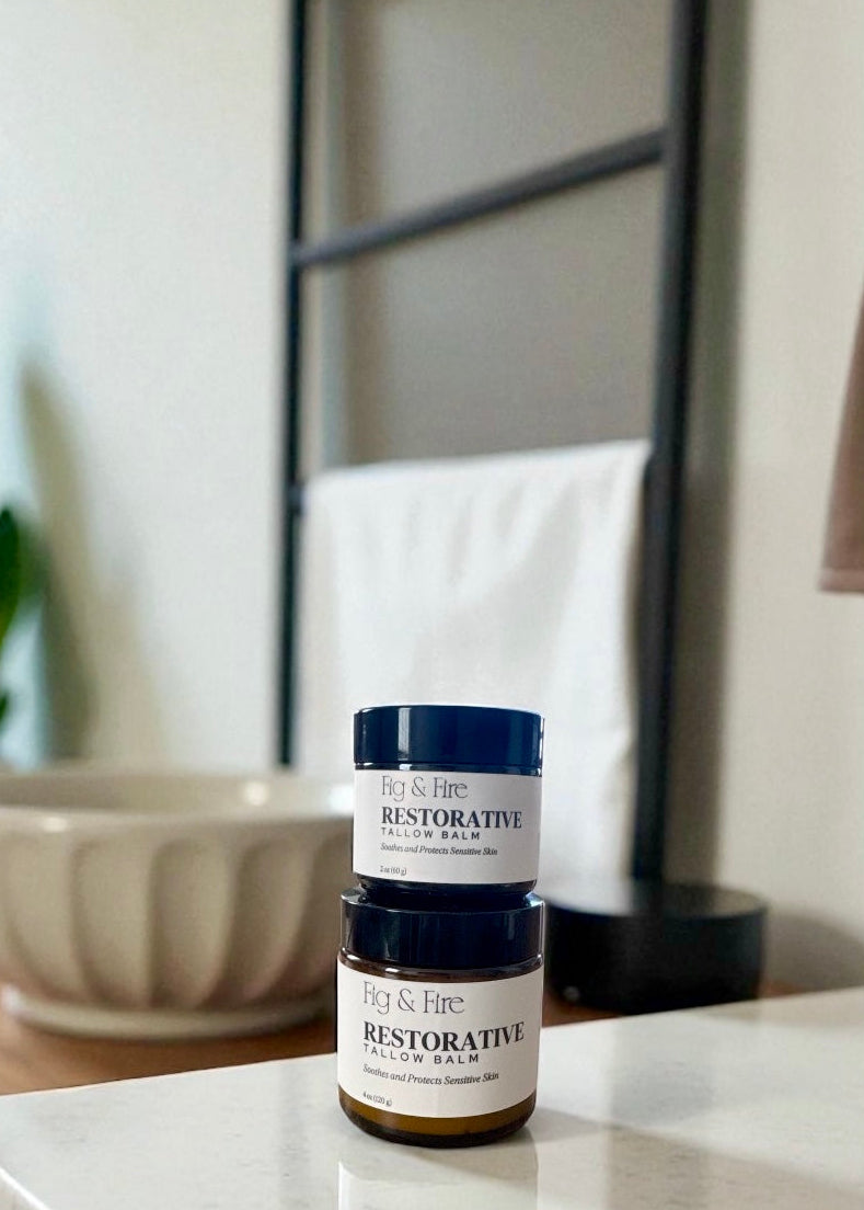 Two jars of Restorative Tallow Balm on a counter. Tallow Balm is made with organic, grass-fed, and pasture-raised tallow. Baby balm. Suitable for all ages.