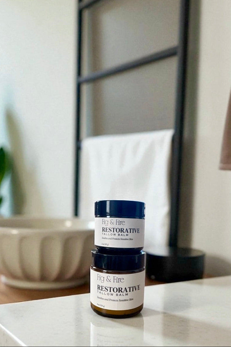 Two jars of Restorative Tallow Balm on a counter. Tallow Balm is made with organic, grass-fed, and pasture-raised tallow. Baby balm. Suitable for all ages.