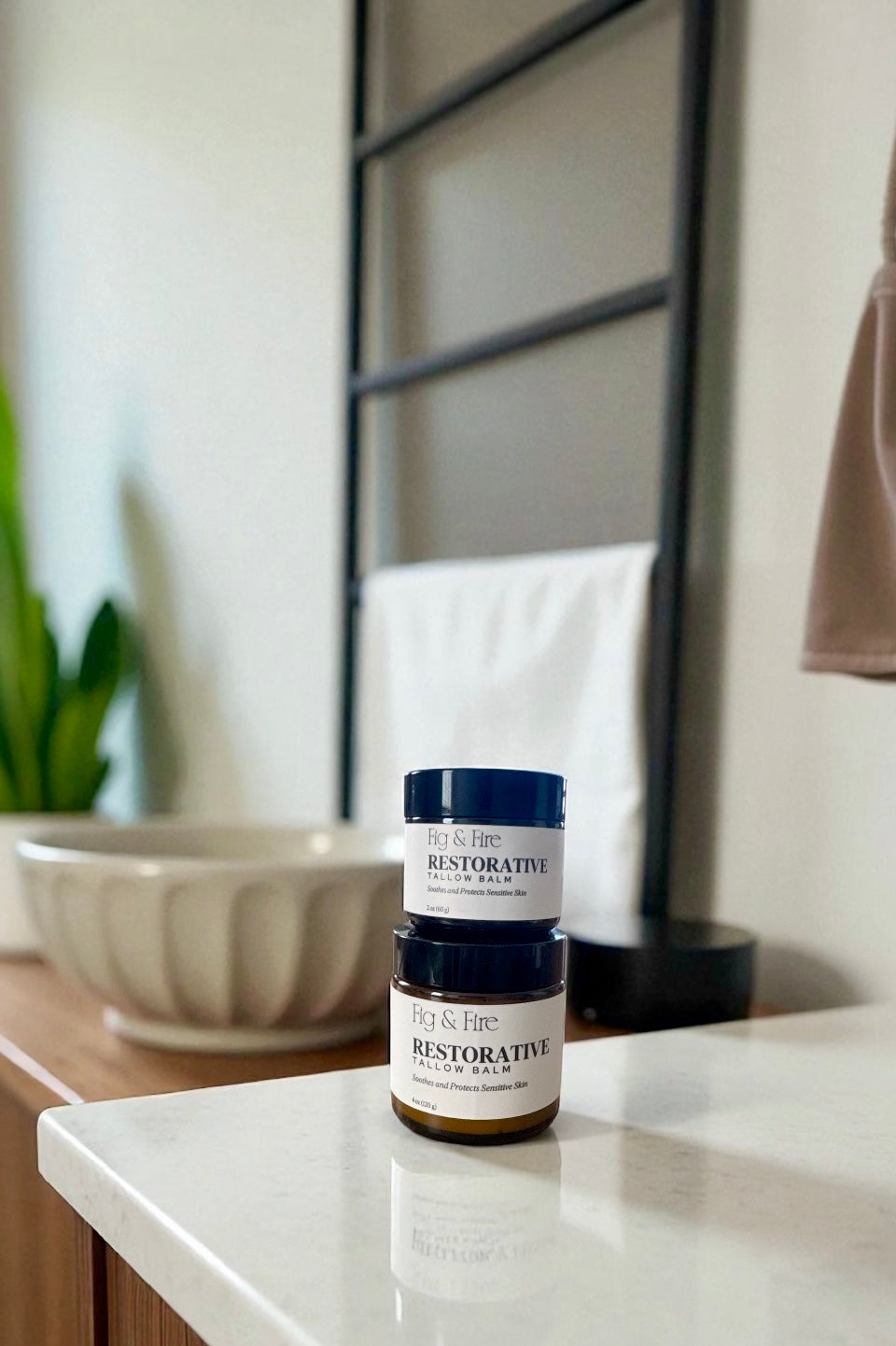 Two jars of Restorative Tallow Balm on a counter. Tallow Balm is made with organic, grass-fed, and pasture-raised tallow. Baby balm. Suitable for all ages.