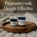 Two jars of Restorative Tallow Balm on a wooden tray on a bed. Tallow Balm is made with organic, grass-fed, and pasture-raised tallow. Baby balm. Suitable for all ages. Text says Non-toxic, pregnancy-safe, deeply effective. Gently by design.