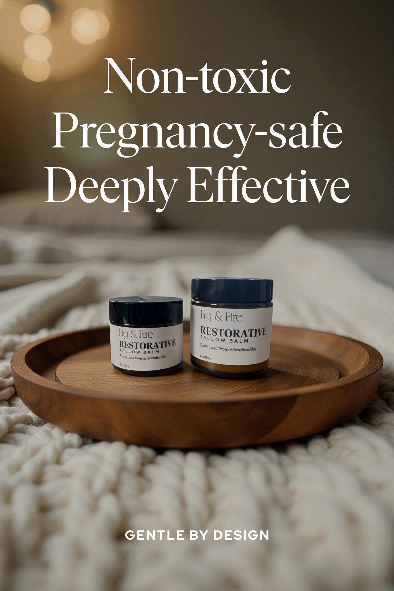 Two jars of Restorative Tallow Balm on a wooden tray on a bed. Tallow Balm is made with organic, grass-fed, and pasture-raised tallow. Baby balm. Suitable for all ages. Text says Non-toxic, pregnancy-safe, deeply effective. Gently by design.
