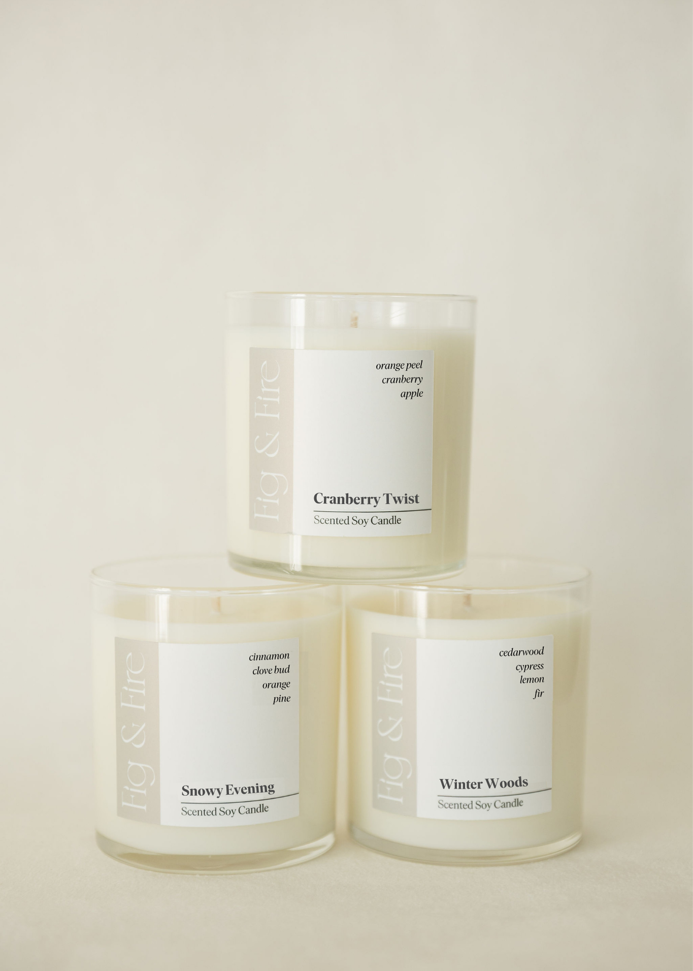 The entire winter collection is featured - Cranberry Twist, Snowy Evening, and Winter Woods - the vessels are clear glass tumblers - all-natural, vegan, soy candles made with essential oils