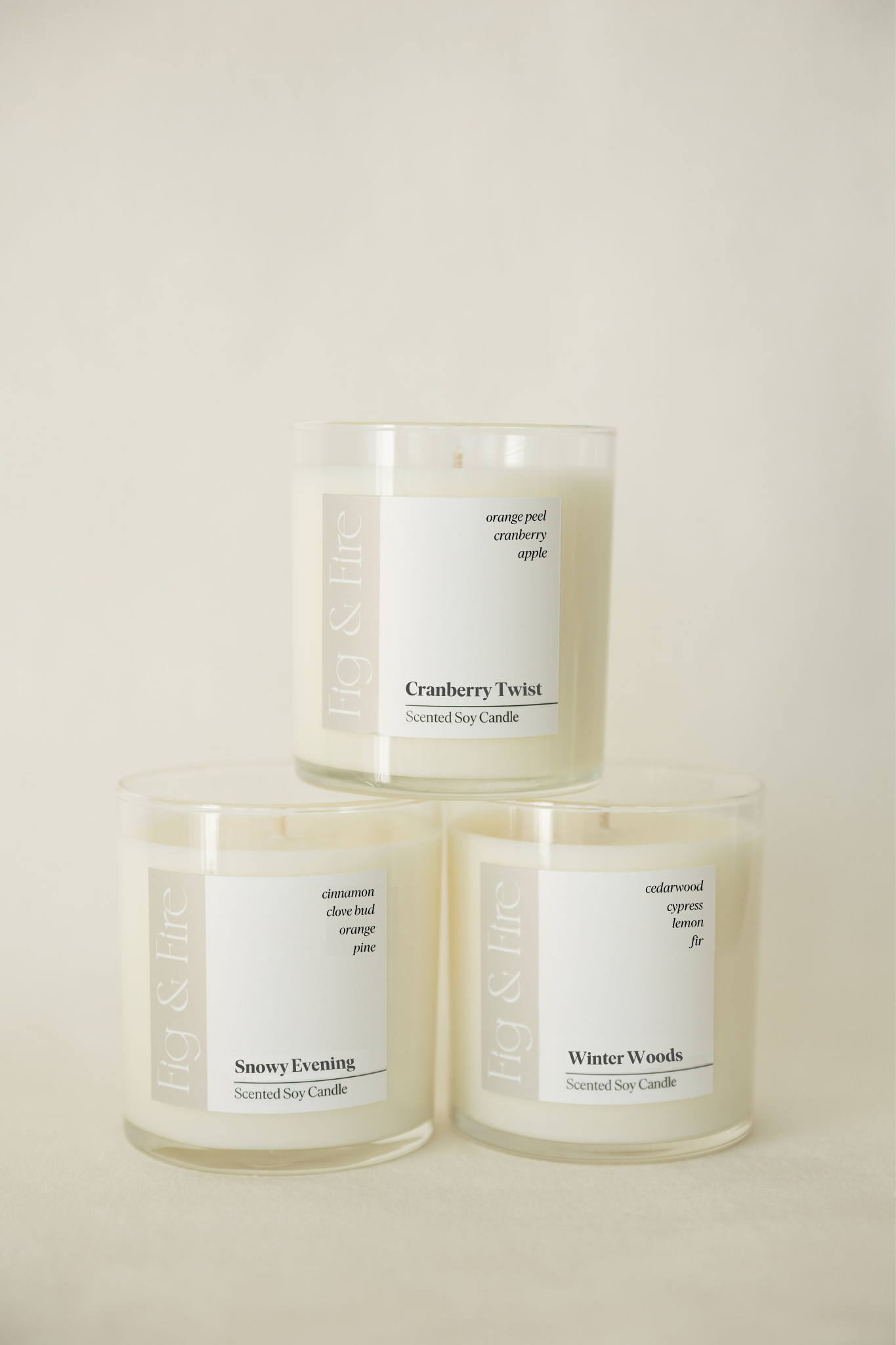 The entire winter collection is featured - Cranberry Twist, Snowy Evening, and Winter Woods - the vessels are clear glass tumblers - all-natural, vegan, soy candles made with essential oils