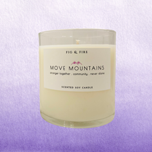 Load image into Gallery viewer, Image of the Move Mountains clear glass candle for The Breasties. Background image has different shades of lavender purple.