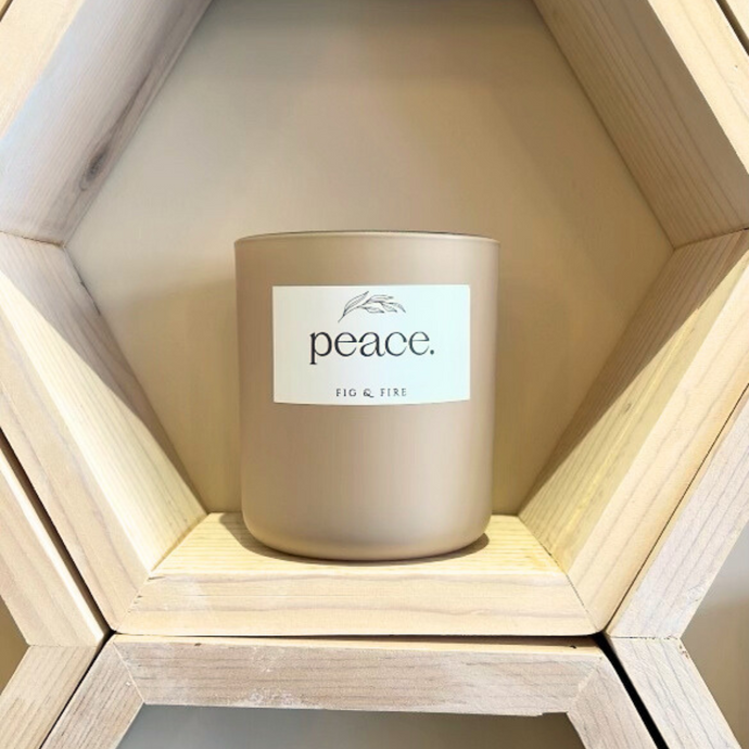 Handcrafted candle - gorgeous neutral colored glass candle with the word “peace” on it. Scent is Peace - smells of lemon verbena, oakmoss, sage, tonka bean, and amber - all natural soy candle - vegan, non-toxic, made with essential oils - container is a 2-wick glass vessel