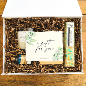 A deluxe gift box with the "a gift for you" watercolor card with green leaves.