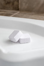 Load image into Gallery viewer, Two shower steamers are pictured on the ledge of a bath tub. These are also called shower bombs.
