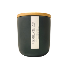 Load image into Gallery viewer, Handcrafted winter candle - scent is frosted orchard - smells of apples, cinnamon, vanilla, maple - all natural soy candle - vegan, non-toxic, made with essential oils, seasonal collection - container is a charcoal ceramic tumbler with a light brown bamboo wooden lid