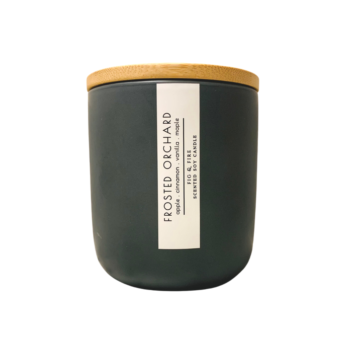 Handcrafted winter candle - scent is frosted orchard - smells of apples, cinnamon, vanilla, maple - all natural soy candle - vegan, non-toxic, made with essential oils, seasonal collection - container is a charcoal ceramic tumbler with a light brown bamboo wooden lid