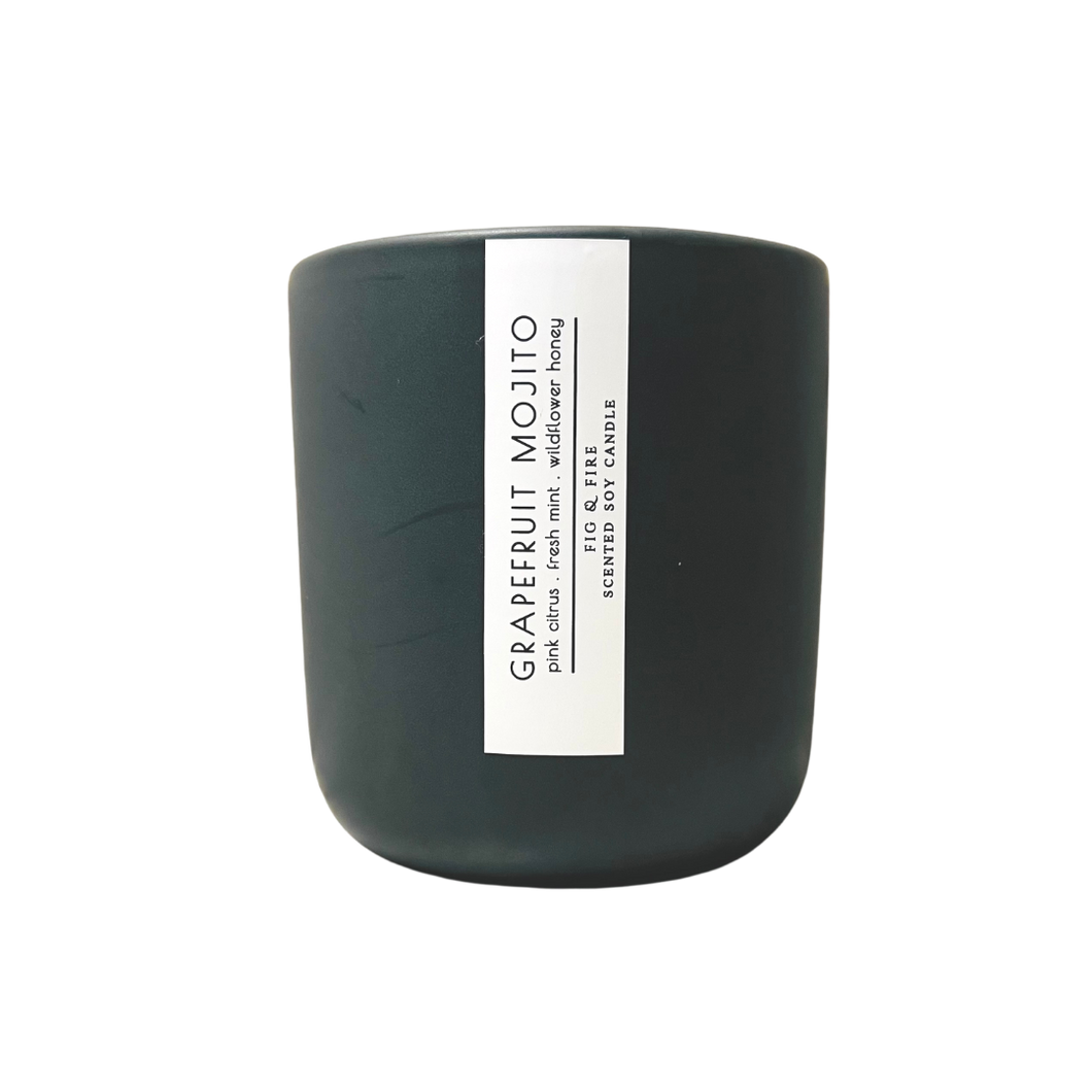 Handcrafted candle - scent is Grapefruit Mojito - smells of pink citrus, fresh mint, and wildflower honey - all natural soy candle - vegan, non-toxic, made with essential oils - container is a charcoal ceramic tumbler