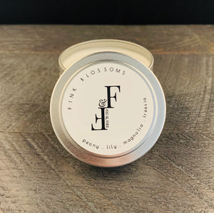 Handcrafted candle - scent is Pink Blossoms - smells of peony, lily, magnolia, and freesia - all natural soy candle - vegan, non-toxic, made with essential oils - container is a silver tin