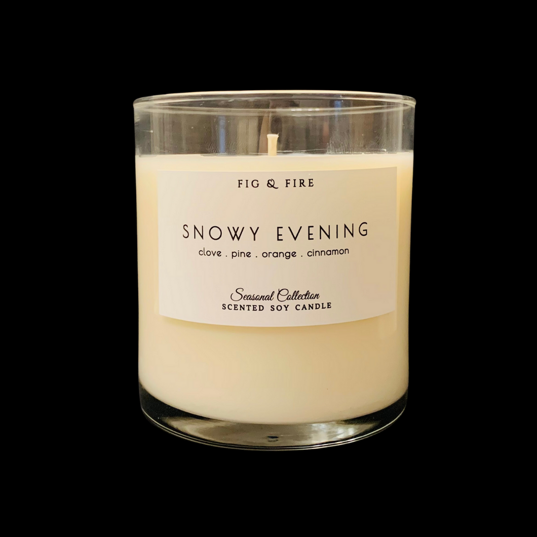 Handcrafted winter candle - scent is snowy evening - smells of clove, pine, orange, and cinnamon - all natural soy candle - vegan, non-toxic, made with essential oils - seasonal collection - container is a clear glass tumbler