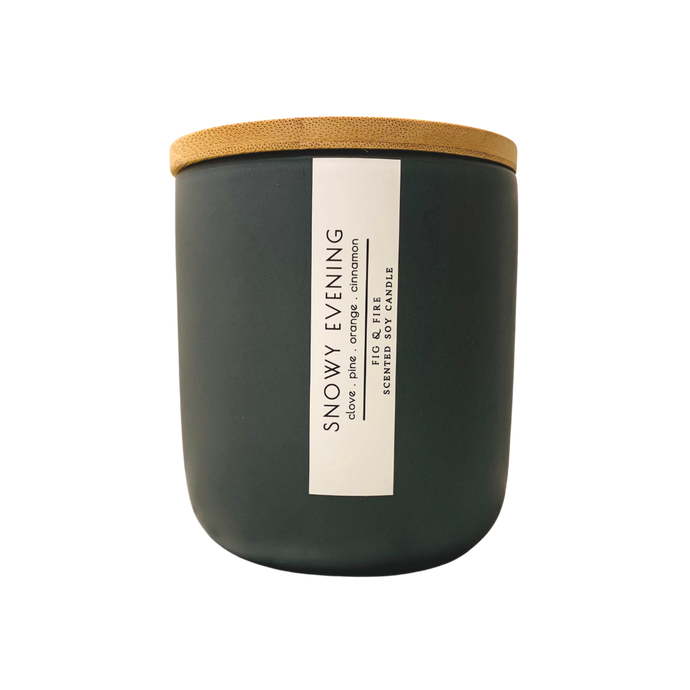 Handcrafted winter candle - scent is snowy evening - smells of clove, pine, orange, and cinnamon - all natural soy candle - vegan, non-toxic, made with essential oils - seasonal collection - container is a charcoal ceramic tumbler with a light brown bamboo wooden lid
