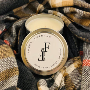 Handcrafted winter candle - scent is snowy evening - smells of clove, pine, orange, and cinnamon - all natural soy candle - vegan, non-toxic, made with essential oils - container is a silver tin - seasonal collection