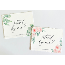 Load image into Gallery viewer, Handcrafted watercolor gift card that says &quot;stand by me?&quot; for a wedding party gift, bridesmaid proposal gift, gift box. Two styles are pictured: one with green leaves and one with pink florals.
