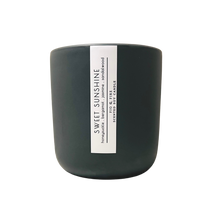 Load image into Gallery viewer, Handcrafted candle - scent is Sweet Sunshine - smells of honeysuckle, bergamot, jasmine, and sandalwood - all natural soy candle - vegan, non-toxic, made with essential oils - container is a charcoal ceramic tumbler