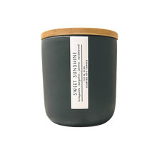 Load image into Gallery viewer, Handcrafted candle - scent is Sweet Sunshine - smells of honeysuckle, bergamot, jasmine, and sandalwood - all natural soy candle - vegan, non-toxic, made with essential oils - container is a charcoal ceramic tumbler with a bamboo wooden lid