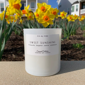 Handcrafted candle - scent is Sweet Sunshine - smells of honeysuckle, bergamot, jasmine, and sandalwood - all natural soy candle - vegan, non-toxic, made with essential oils - container is a white glass tumbler