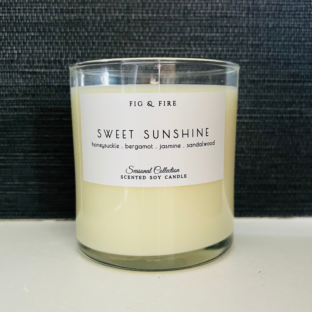 Handcrafted candle - scent is Sweet Sunshine - smells of honeysuckle, bergamot, jasmine, and sandalwood - all natural soy candle - vegan, non-toxic, made with essential oils - container is a clear glass tumbler