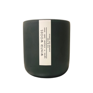 Handcrafted winter candle - scent is winter woods - smells of cypress, fir, evergreen, cedar, and lemon - all natural soy candle - vegan, non-toxic, made with essential oils - seasonal collection - container is a charcoal ceramic tumbler