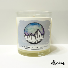 Load image into Gallery viewer, Clear glass candle with original artwork: snowy mountains with a purple, green, and blue sky, and watercolor background.